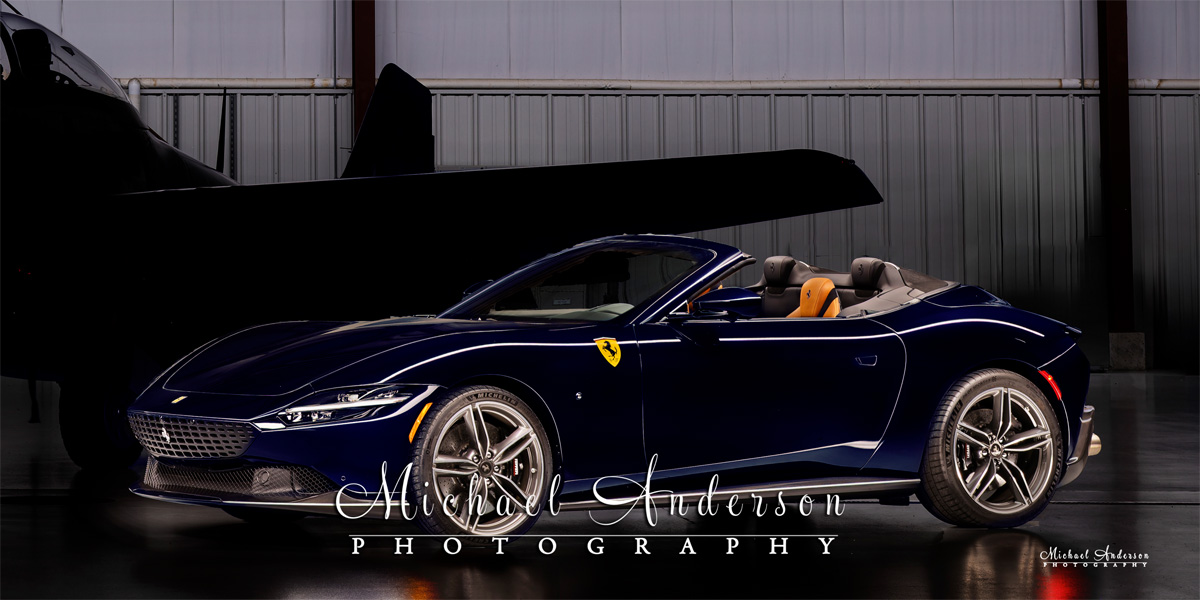 A cool light painted photograph of a blue 2025 Ferrari Roma Spider. This image was created as part of a 3-vehicle light painting at the airport in Oshkosh, WI.