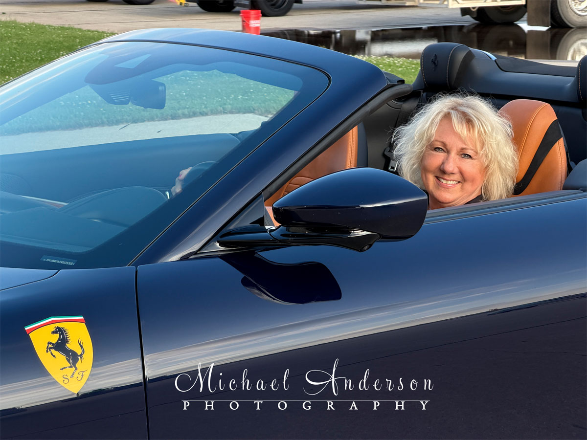 Professional photographer sitting in a Ferrari Roma Spider.