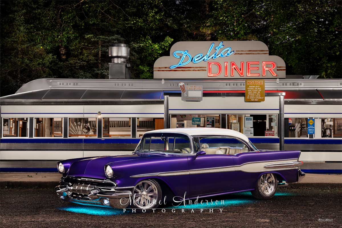 A stunning light-painted photograph of a 1957 Pontiac Chieftain (with its puddle lights on) in front of the Delta Diner in Mason, Wisconsin.