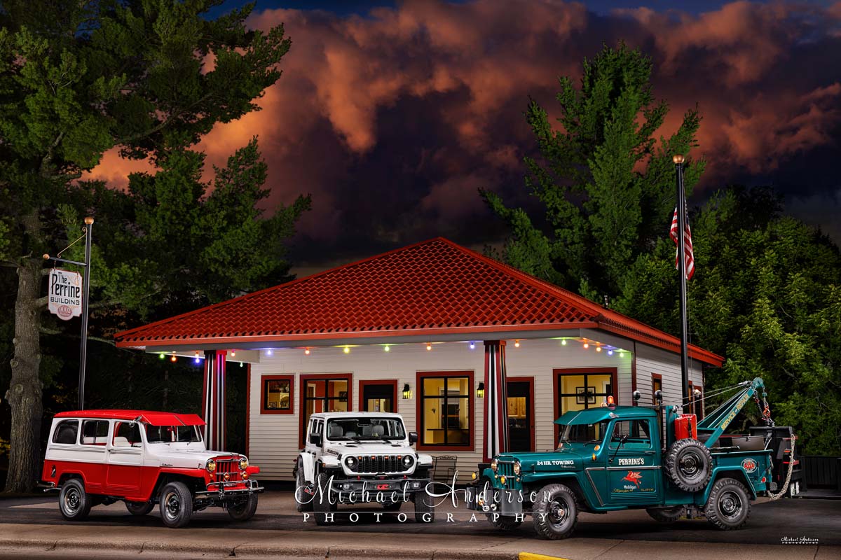 A stunning light-painted photo of the historic Sturgeon Lake Mobile Gas Station (now a real estate office). Also featured in the one-of-a-kind image are a 1960 Willys Jeep one-ton 4x4 Station Wagon, a 2025 Jeep Wrangler Rubicon X, as well as a stunning 1963 Willys Jeep 4x4 Truck with a factory-installed Canfield Wrecker.