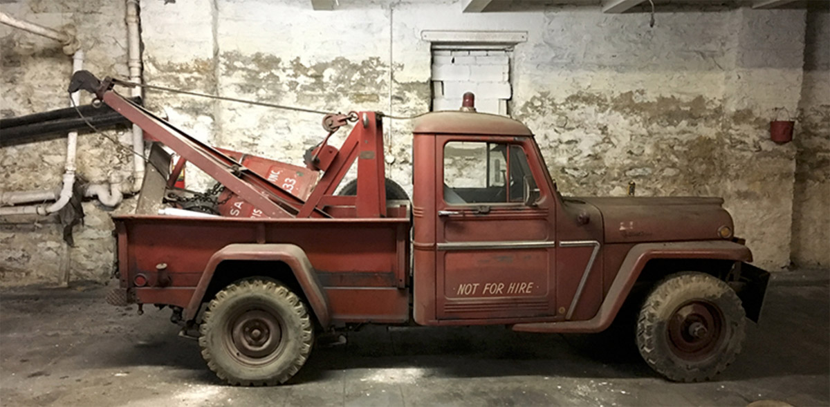 An old photo of a 1963 Willys Jeep Truck.
