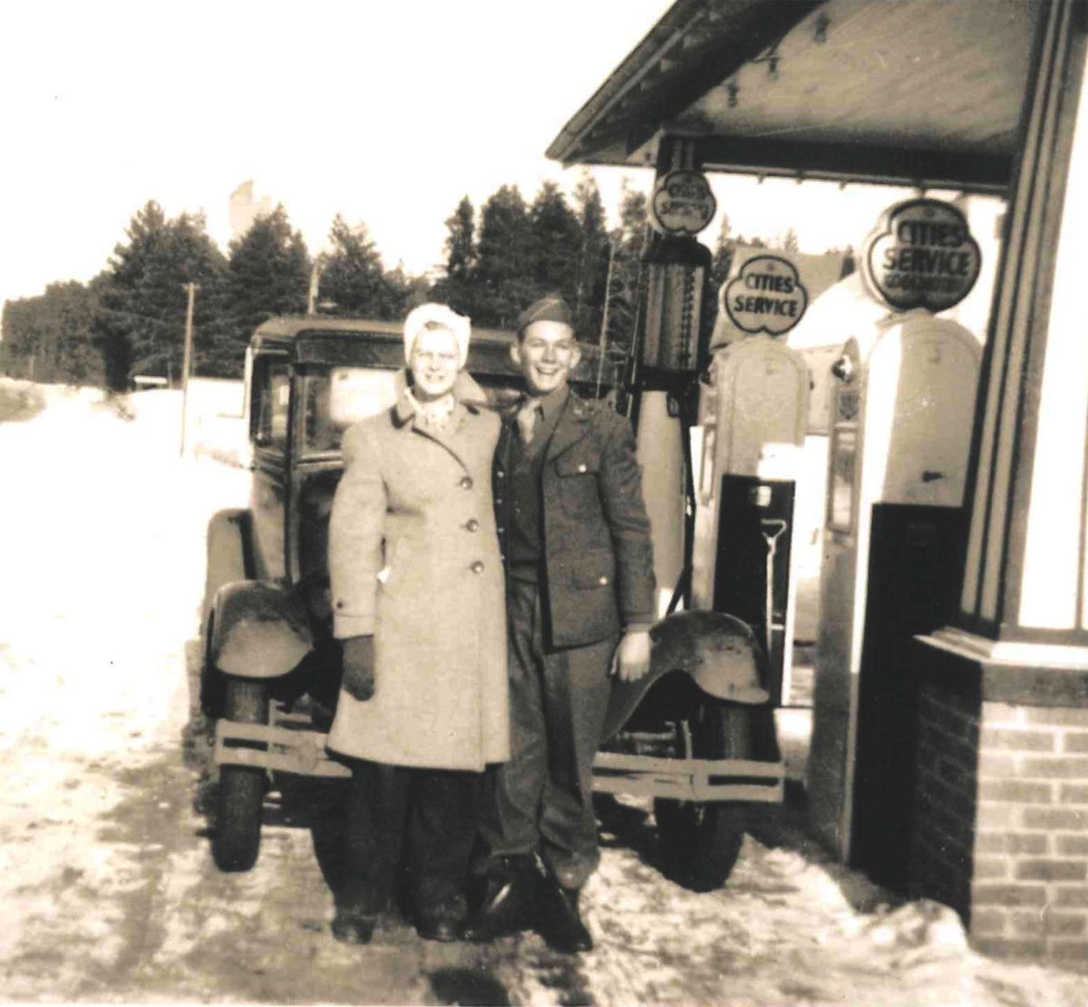 World War II soldier and his girlfriend in front of the historic Sturgeon Lake Mobile Gas Station.